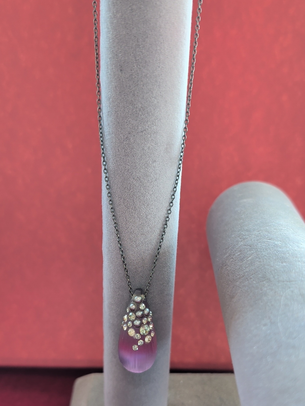Alexis Bittar purple teardrop lucite pendant with crystal accents on dark chain